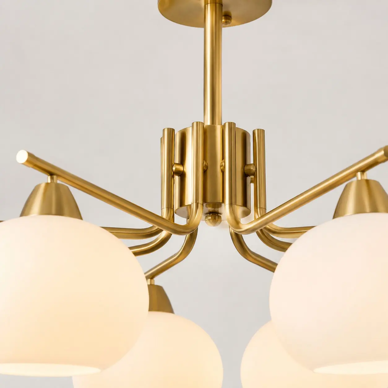 Gold chandelier center structure and arm junction detail