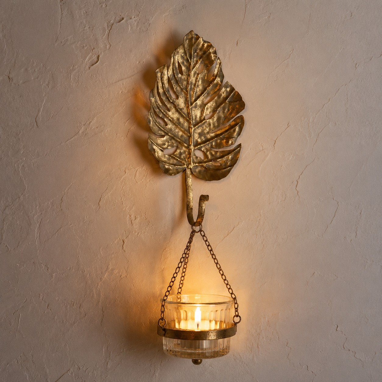 Antique-gold leaf hook styled with a candle holder