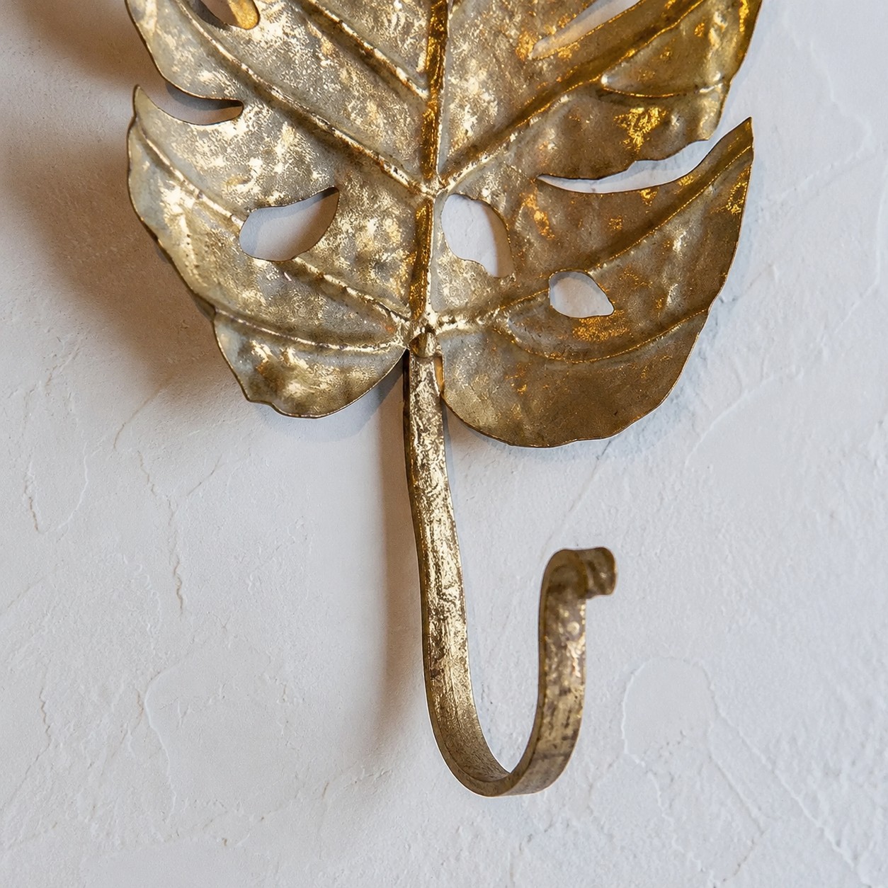 Curved iron hook and leaf joint detail