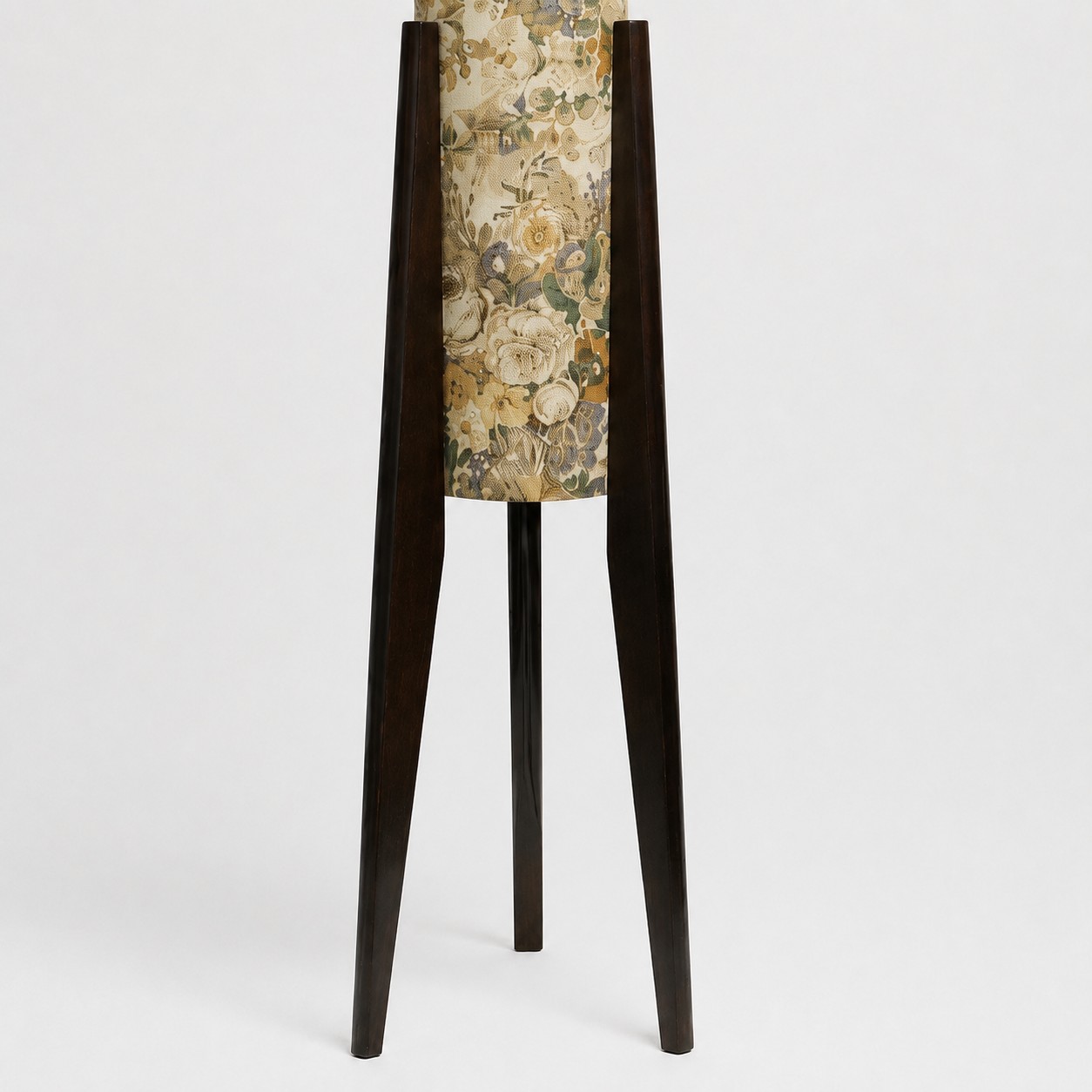 Close-up of dark solid wood tripod legs and central floor lamp stem